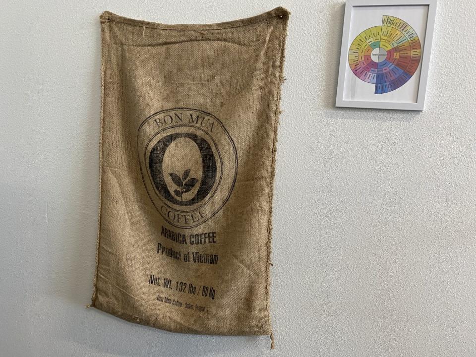 A pouch for green coffee beans is hung on the wall of the Bon Mua roastery.