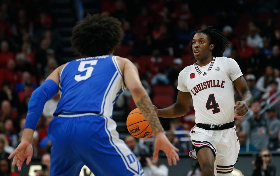 Louisville’s Ty-Laur Johnson brings the ball upcourt against Duke’s Tyrese Proctor. Johnson scored 10 points in the ACC loss.