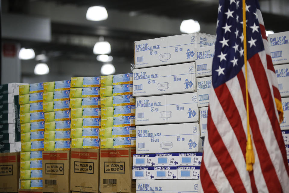 FILE - In this March 24, 2020, file photo stacks of medical supplies are housed at the Jacob Javits Center that will become a temporary hospital in response to the COVID-19 outbreak in New York. A review of federal purchasing contracts by The Associated Press shows federal agencies waited until mid-March to begin placing bulk orders of N95 respirator masks, mechanical ventilators and other equipment needed by front-line health care workers. (AP Photo/John Minchillo, File)