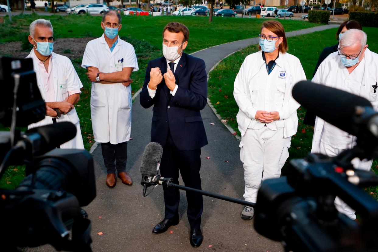 French President Emmanuel Macron speaks to the press after chairing a meeting with the medical staff of the Rene Dubos hospital center, in Pontoise, in the Val d'Oise, on Oct. 23, 2020, as the country faces a new wave of infections of COVID-19.