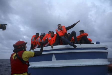 Proactive Open Arms rescuers gesture to a migrant to jump on a RHIB during a search and rescue operation north of the Libyan city of Sabratha in central Mediterranean Sea, March 29, 2017. REUTERS/Yannis Behrakis