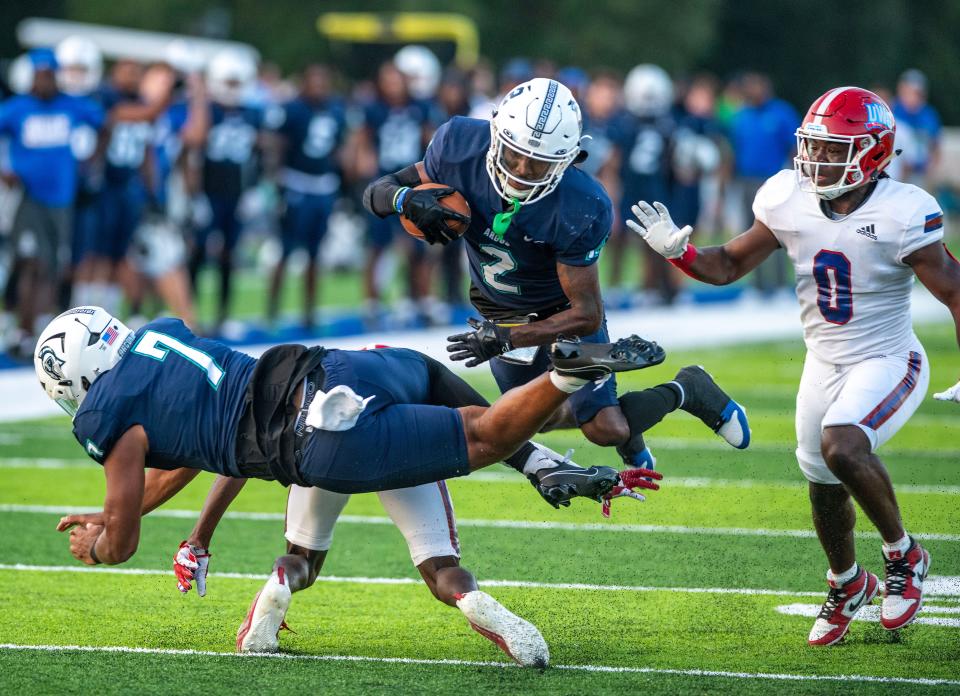 West Florida's KJ Franklin leaps over players during the Gulf South Conference opener against West Georgia at Pen Air Field at the University of West Florida Saturday, September 23, 2023.