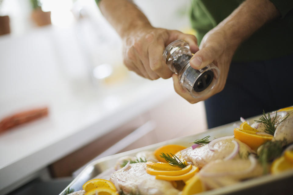 Grinding pepper on chicken