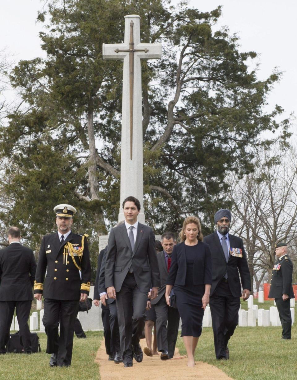 Prime Minister Justin Trudeau, his wife Sophie Gregoire Trudeau and Defence Minister Harjit Sajjan walk away from the Canadian Cross of Sacrifice after laying a wreath at the Arlington Cemetery Friday, March 11, 2016 in Arlington, Virginia. THE CANADIAN PRESS/Paul Chiasson