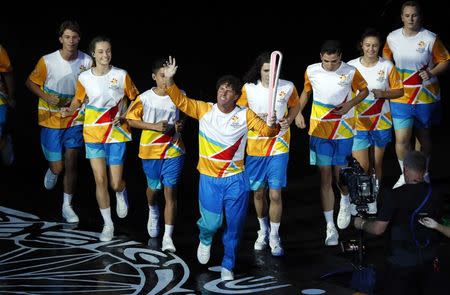 Gold Coast 2018 Commonwealth Games - Opening ceremony - Carrara Stadium - Gold Coast, Australia - April 4, 2018 - Brent Livermore carries the baton during the opening ceremony. REUTERS/David Gray