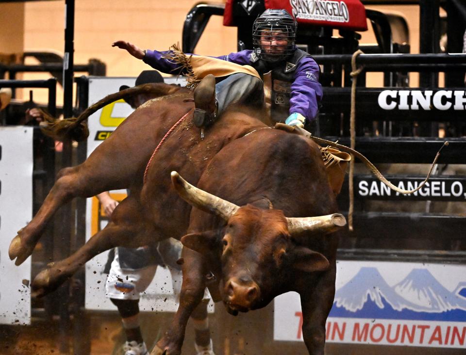 Kacy Ray Jones of Newcastle, Wyoming starts to slide off of Too Cool during Bull Riding at the San Angelo Rodeo Saturday April 6, 2024.