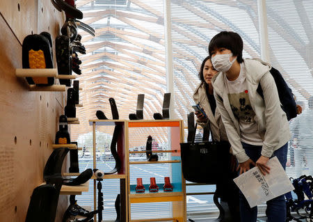Visitors look around prosthetic "blades" during an opening ceremony of a special "library" that lets people borrow and try out prosthetic "blades" for runners, in Tokyo, Japan, October 15, 2017. Picture taken October 15, 2017. REUTERS/Kim Kyung-Hoon