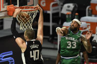 Los Angeles Clippers center Ivica Zubac, left, dunks past Dallas Mavericks center Willie Cauley-Stein during the first half of an NBA basketball game in Los Angeles Sunday, Dec. 27, 2020. (AP Photo/Kyusung Gong)