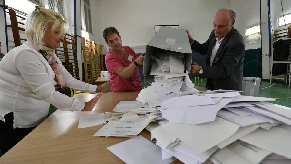 Members of a local election committee empty a ballot box for counting at a polling station at the end of local elections in Budapest, Hungary, Sunday Oct. 13, 2019. Prime Minister Viktor Orban's dominant right-wing Fidesz party was facing a challenge Sunday from opposition parties who are backing joint candidates in many cities in Hungary's nationwide local election. (Zsolt Szigetvary/MTI via AP)