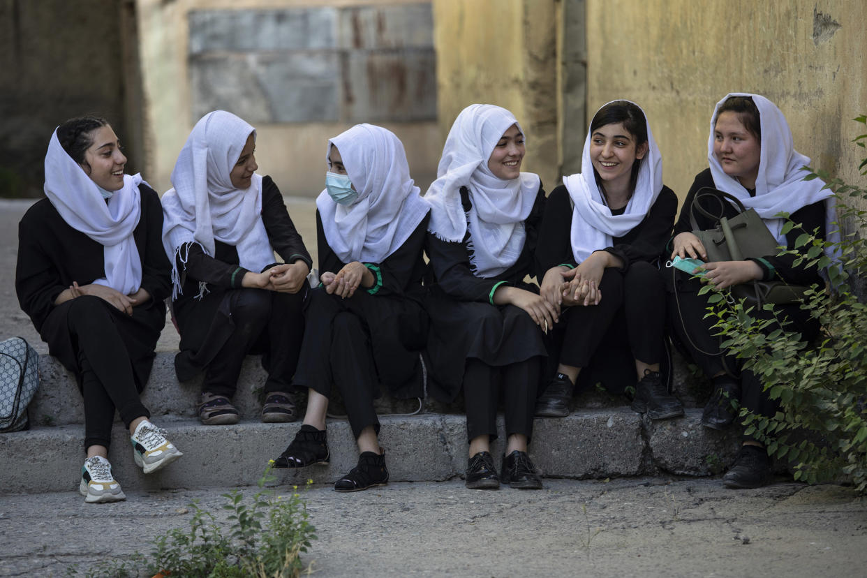 Image: Afghan female students talk after school outside the Zarghoona high school (Paula Bronstein / Getty Images)