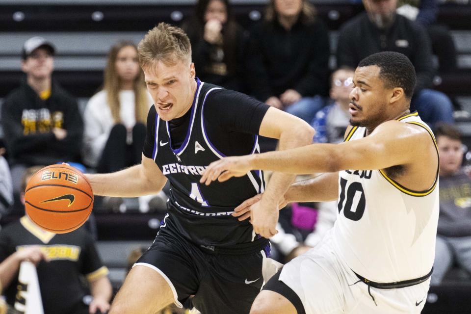 Central Arkansas' Johannes Kirsipuu, left, drives past Missouri's Nick Honor, right, during the first half of an NCAA college basketball game Saturday, Dec. 30, 2023, in Columbia, Mo. (AP Photo/L.G. Patterson)