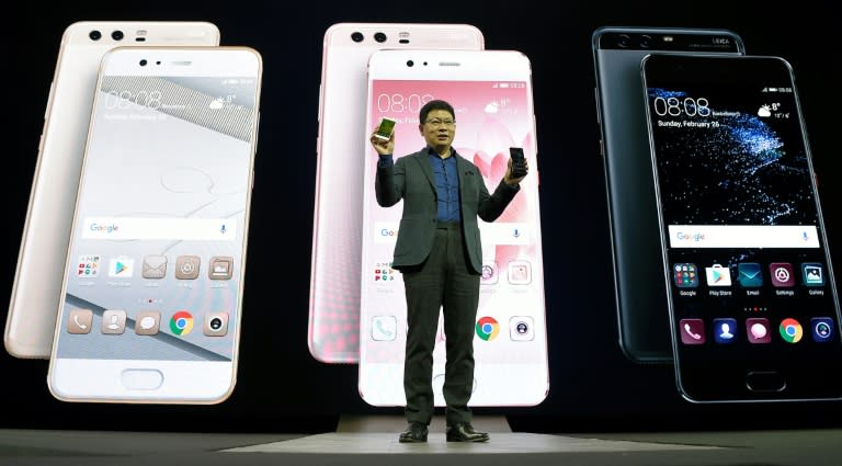 Chinese multinational networking and telecommunications equipment and services company Huawei's CEO Richard Yu presents e Huawei's new P10 phone during a press conference on February 26, 2017 in Barcelona on the eve of the Mobile World Congress