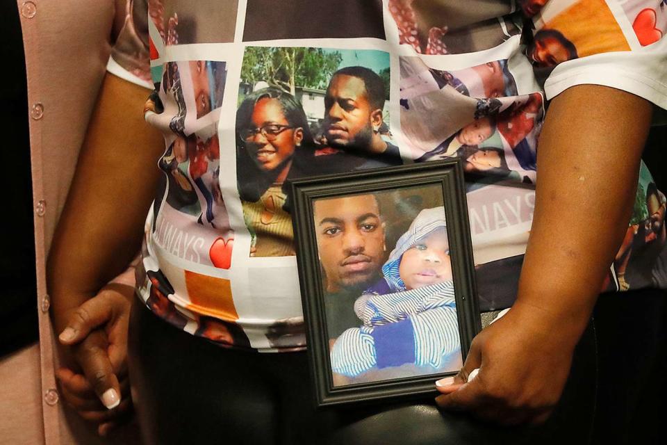 <p>Luis Sinco/ Los Angeles Times via Getty</p> Tommi Fineman holds a photo of her son Ryan Twyman