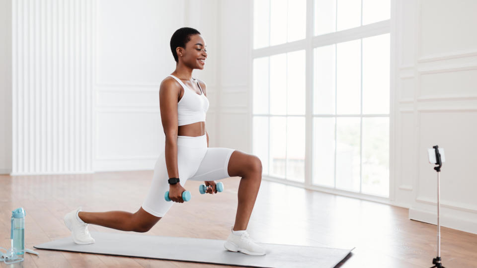 A woman performing a reverse lunge