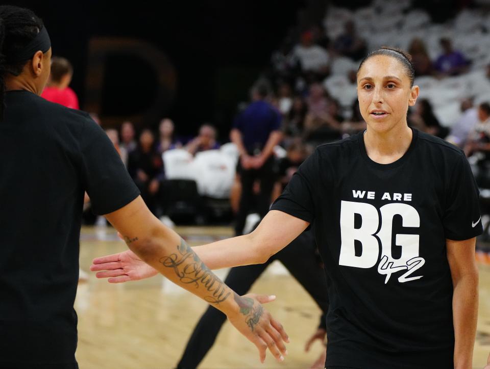 Mercury's Diana Taurasi high-fives teammates in warmups wearing a 'We are BG42' shirt in honor of teammate Brittney Griner during the home opener.
