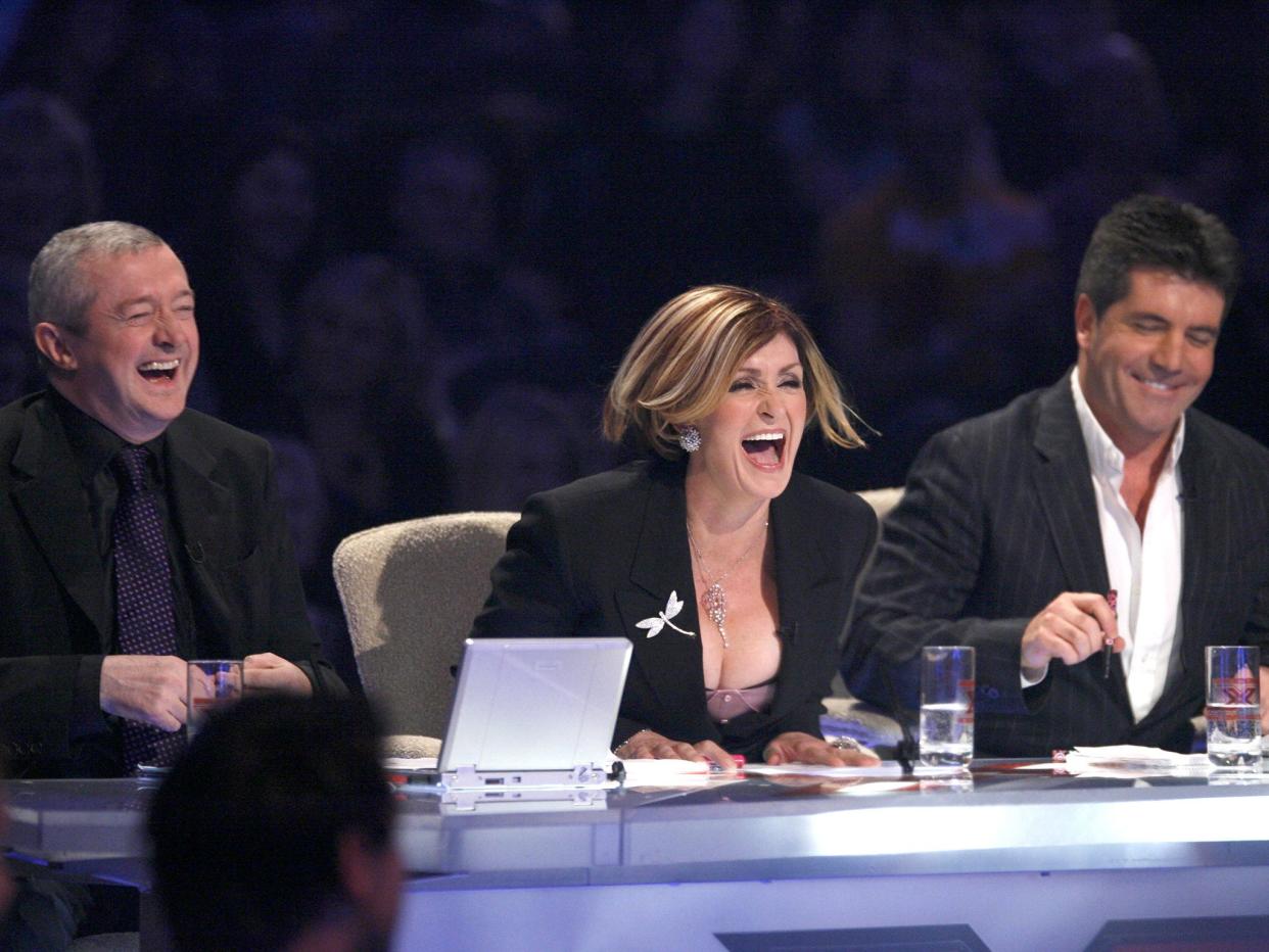 Louis Walsh, Sharon Osbourne and Simon Cowell at the judges’ table on ‘The X Factor’ in 2005 (Ken McKay/Shutterstock)