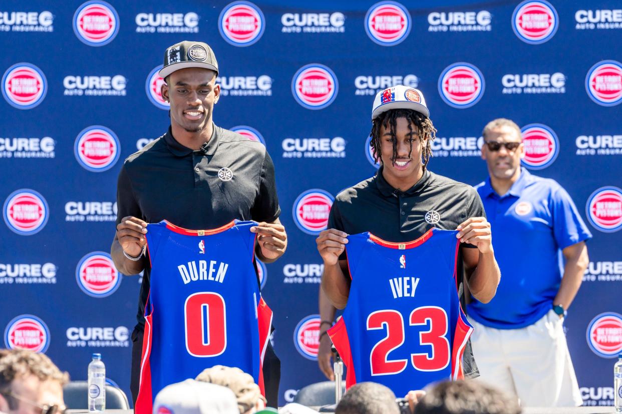 Pistons draft picks Jalen Duren, left, and Jaden Ivey pose for photos with their new jerseys during the Pistons' Introductory news conference on Friday, June 24, 2022, at Rouge Park.