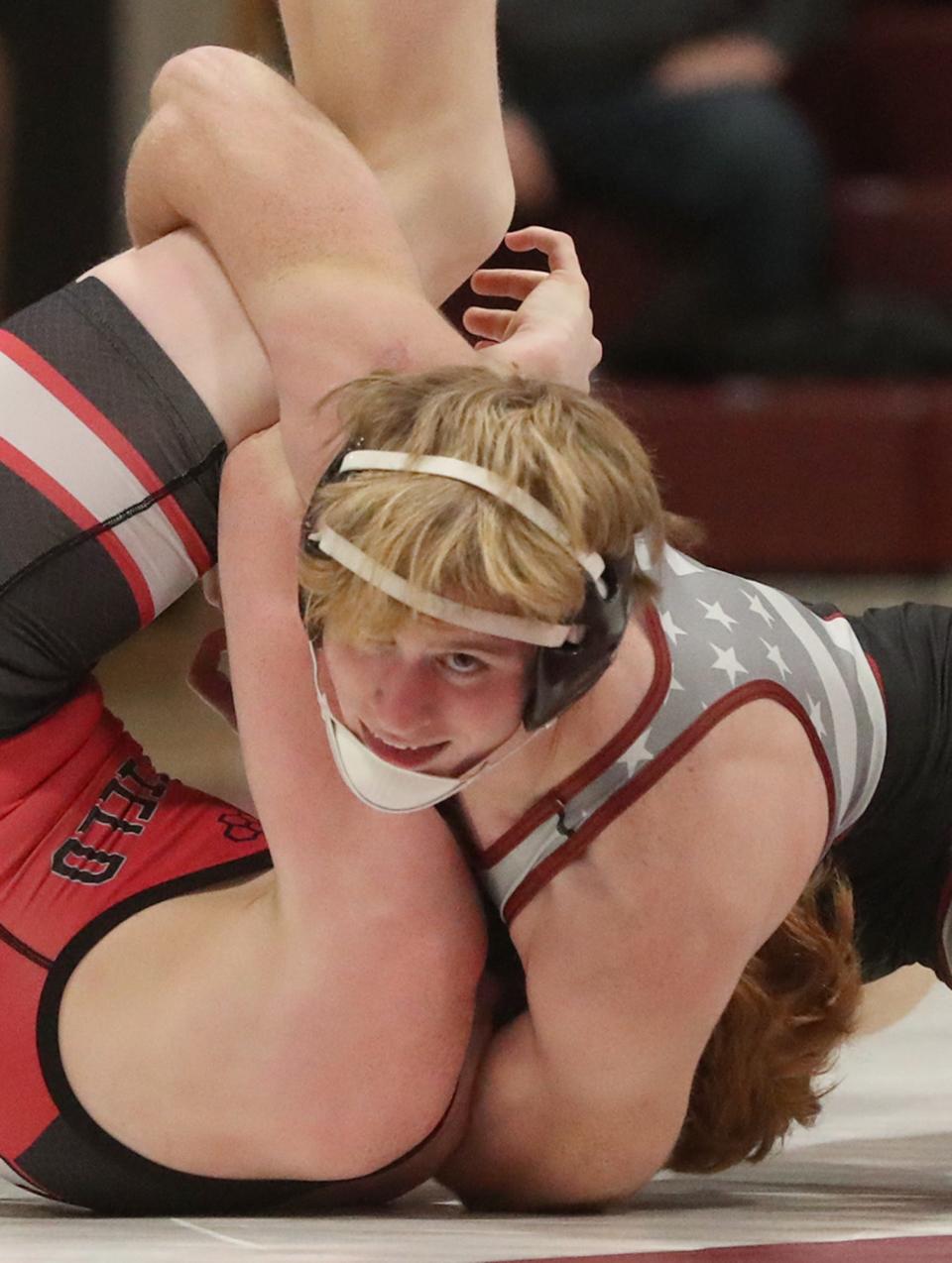 Woodridge's David Thompson looks up as he pins Springfield's Kam Wilkinson in their 132-pound match Thursday. [Mike Cardew/Beacon Journal]