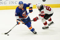 New Jersey Devils' Jack Hughes (86) fights for control of the puck with New York Islanders' Kyle Palmieri (21) during the third period of an NHL hockey game Saturday, May 8, 2021, in Uniondale, N.Y. The Islanders won 5-1. (AP Photo/Frank Franklin II)