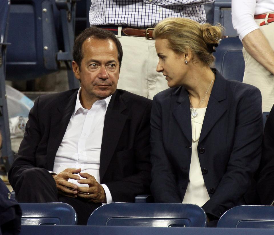 Billionaire hedge fund manager John Paulson and his wife, Jenny, attend a tennis match during the U.S. Open in New York on Sept. 5, 2012.