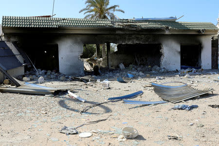 FILE PHOTO: A damaged building is seen during a fight between members of the Libyan internationally recognised government forces and Eastern forces in al-Yarmouk south of Tripoli, Libya May 7, 2019. REUTERS/Hani Amara/File Photo