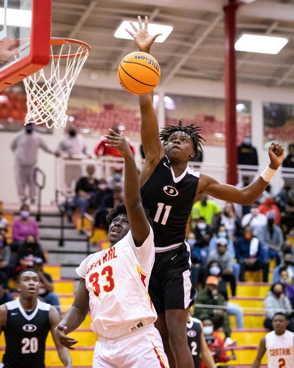 Dutchtown's Coen Carr (11) blocks a shot from Clarke Central's Kahari  Dean (33) during a playoff basketball game between the Clarke Central Gladiators and the Dutchtown Bulldogs at Clarke Central High School in Athens, Ga., on Wednesday, March 3, 2021. Dutchtown was up big early on and held onto a narrowing lead in the second half to beat out Clarke Central 72-64 and advance to the next round of the playoffs. (Casey Sykes for The Athens Banner-Herald)