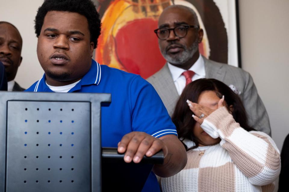 <p>Ben Gray/Atlanta Journal-Constitution via AP</p> Treveon Taylor Sr., at lectern, and Jessica Ross