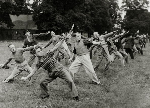 <p>Home Guard members still dressed in their ‘civvies’ practice hand grenade throwing in 1940. (Popperfoto/Getty Images)</p>