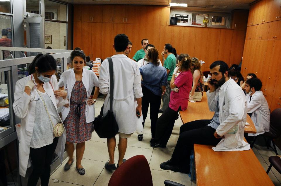 FILE - In this June 1, 2013, file photo, volunteer Turkish doctors and medical personnel at a makeshift clinic near Taksim Square in Istanbul, Turkey. During the height of Turkey's summer of upheaval, more than a dozen Turkish doctors interviewed by The Associated Press say authorities assaulted them with tear gas, pressured them to reveal the names of patients and ignored calls for resources. (AP Photo/Emrah Gurel, File)