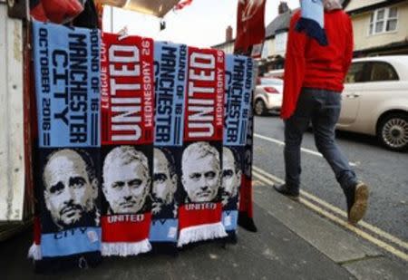 Football Soccer Britain - Manchester United v Manchester City - EFL Cup Fourth Round - Old Trafford - 26/10/16 Scarves with the faces of Manchester City manager Pep Guardiola and Manchester United manager Jose Mourinho are sold outside the stadium before the match Action Images via Reuters / Jason Cairnduff Livepic EDITORIAL USE ONLY. No use with unauthorized audio, video, data, fixture lists, club/league logos or "live" services. Online in-match use limited to 45 images, no video emulation. No use in betting, games or single club/league/player publications. Please contact your account representative for further details.