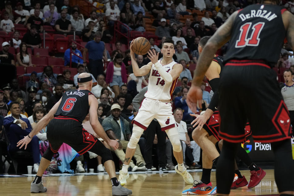Miami Heat guard Tyler Herro (14) looks to pass the ball during the first half of an NBA basketball play-in tournament game against the Chicago Bulls, Friday, April 14, 2023, in Miami. (AP Photo/Rebecca Blackwell)