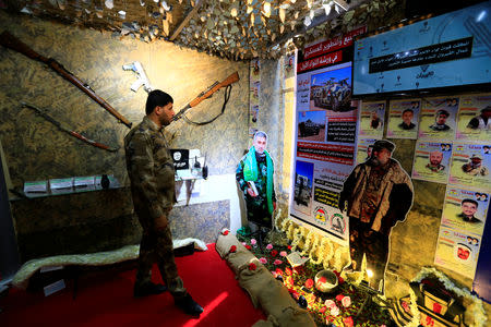 A member of Hashid Shaabi looks at the Popular Mobilisation Forces (PMF) section of the Baghdad International Fair in Baghdad, Iraq, November 10, 2018. Picture taken November 10, 2018. REUTERS/Thaier al-Sudani