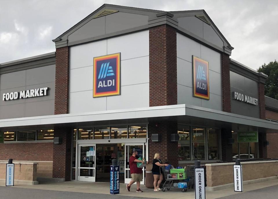 The Franco family walks their Aldi finds out to their vehicle in Chester.