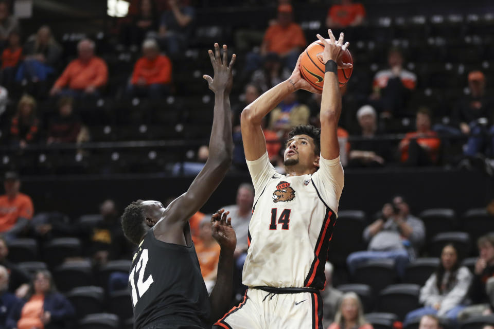 Oregon State forward Jayden Stevens (14) drives to the basket as Colorado forward Bangot Dak (12) defends during the first half of an NCAA college basketball game Saturday, March 9, 2024, in Corvallis, Ore. (AP Photo/Amanda Loman)