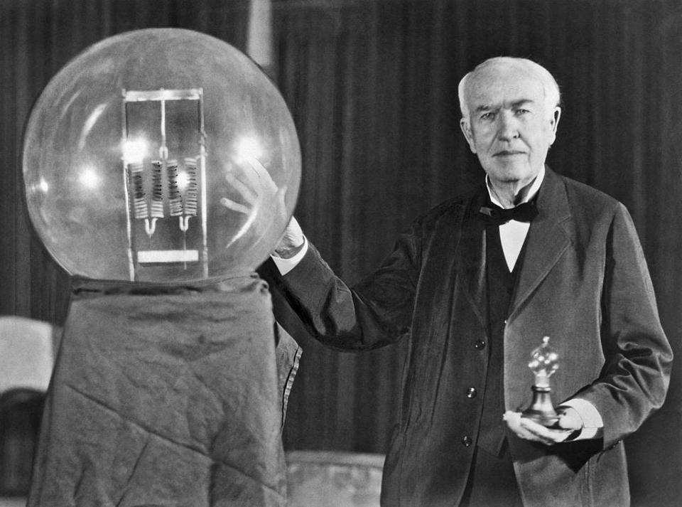 Inventor Thomas Edison poses in 1929 with a replica of his first  successful incandescent lamp. The photo was taken during an anniversary banquet in his honor in Orange, New Jersey.