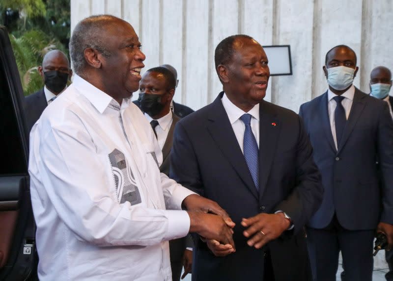 Ivory Coast's President Alassane Ouattara meets former President Laurent Gbagbo during a meeting at the presidential palace in Abidjan