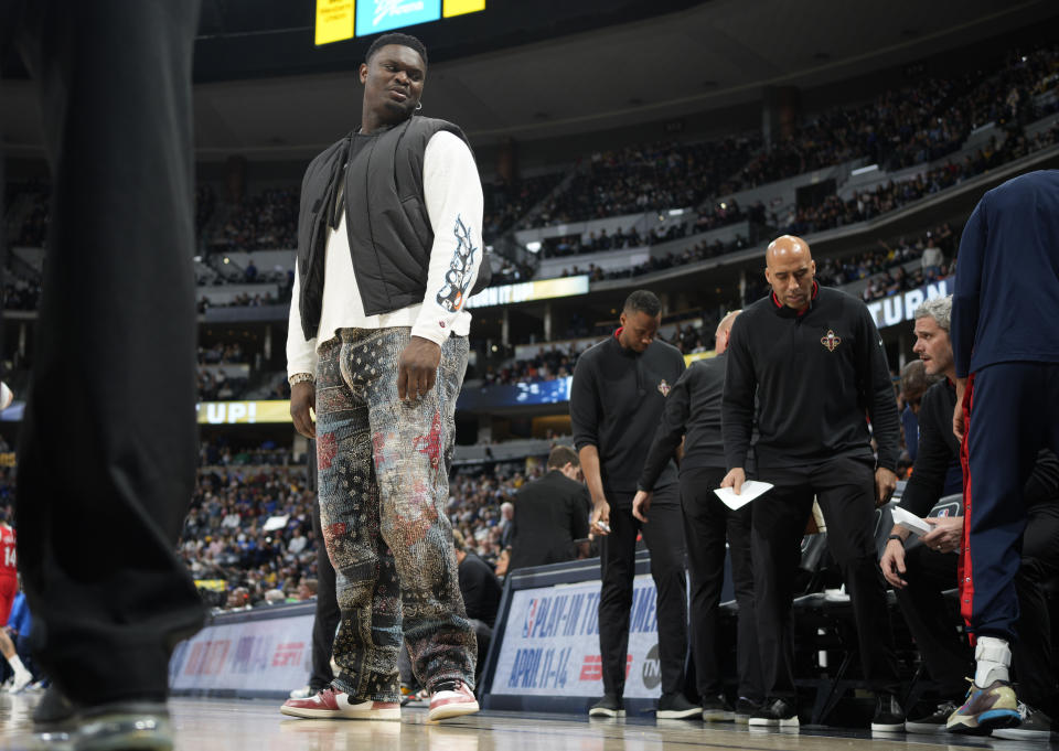 Injured New Orleans Pelicans forward Zion Williamson heads back to the bench after a timeout late in the second half of the team's NBA basketball game against the Denver Nuggets on Thursday, March 30, 2023, in Denver. (AP Photo/David Zalubowski)