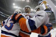 Apr 16, 2019; Pittsburgh, PA, USA; New York Islanders center Mathew Barzal (13) and defenseman Adam Pelech (middle) and right wing Jordan Eberle (7) celebrate a goal by Eberle against the Pittsburgh Penguins during the first period in game four of the first round of the 2019 Stanley Cup Playoffs at PPG PAINTS Arena. The Islanders won the game 3-1 and swept the series four games to none. Mandatory Credit: Charles LeClaire-USA TODAY Sports