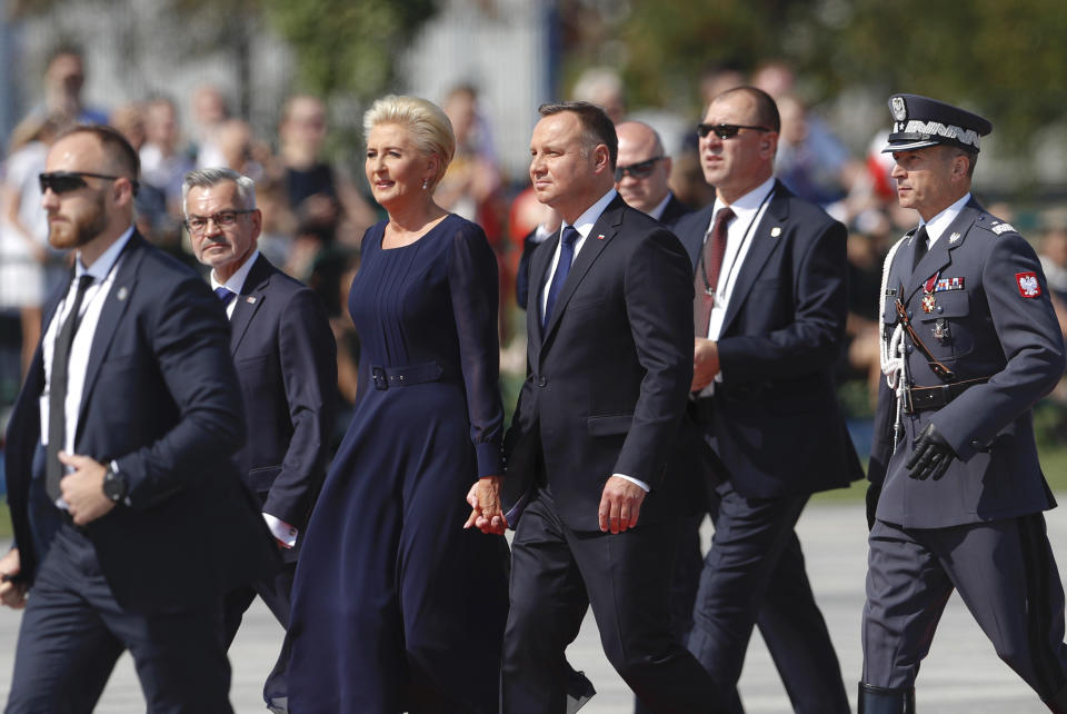 Polish President Andrzej Duda, center right, and his wife Agata Kornhauser-Duda arrive for a memorial ceremony marking the 80th anniversary of the start of World War II in Warsaw, Poland, Sunday, Sept. 1, 2019. (AP Photo/Petr David Josek)