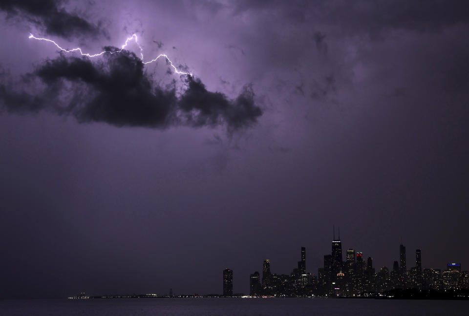 Lightning strikes above downtown Chicago as a storm moves over Lake Michigan following two days of unseasonably warm weather, Tuesday, Feb. 27, 2024. (Chris Sweda/Chicago Tribune via AP)