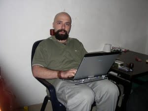 Bald guy on a laptop