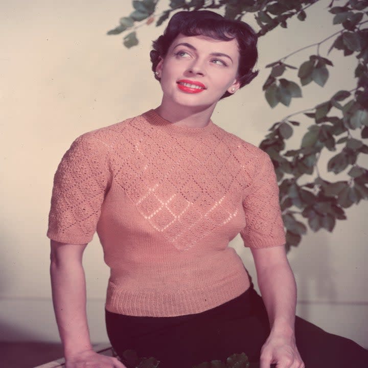 Woman wearing a crochet top in 1955