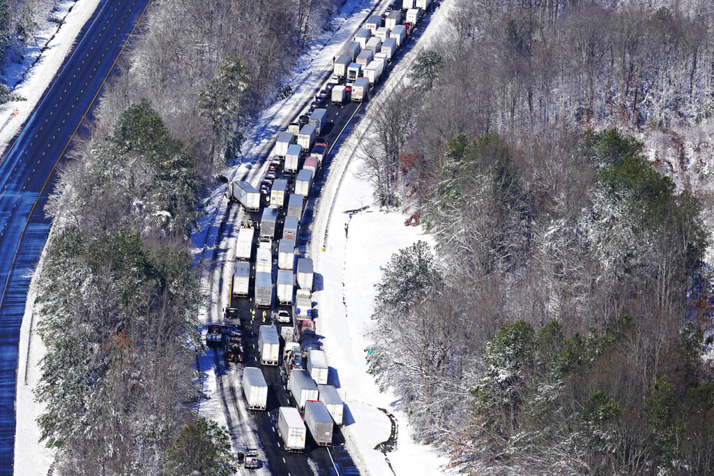 Drivers wait for the traffic to be cleared Tuesday as cars and trucks are stranded on sections of Interstate 95 in Virginia. (AP Photo/Steve Helber)