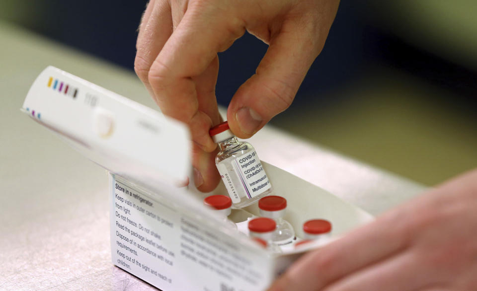 Doses of the COVID-19 vaccine developed by Oxford University and U.K.-based drugmaker AstraZeneca are checked as they arrive at the Princess Royal Hospital in Haywards Heath, England, Saturday Jan. 2, 2021. The UK has 530,000 doses available for rollout from Monday. (Gareth Fuller/Pool via AP)