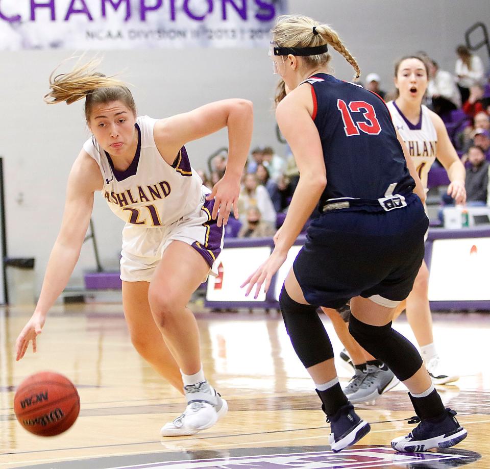 Ashland University's Macy Spielman (21) drives with the ball against Malone University's Madison Hunter (13) during college women's basketball action Wednesday, Dec. 29, 2021 at Kates Gymnasium. TOM E. PUSKAR/TIMES-GAZETTE.COM