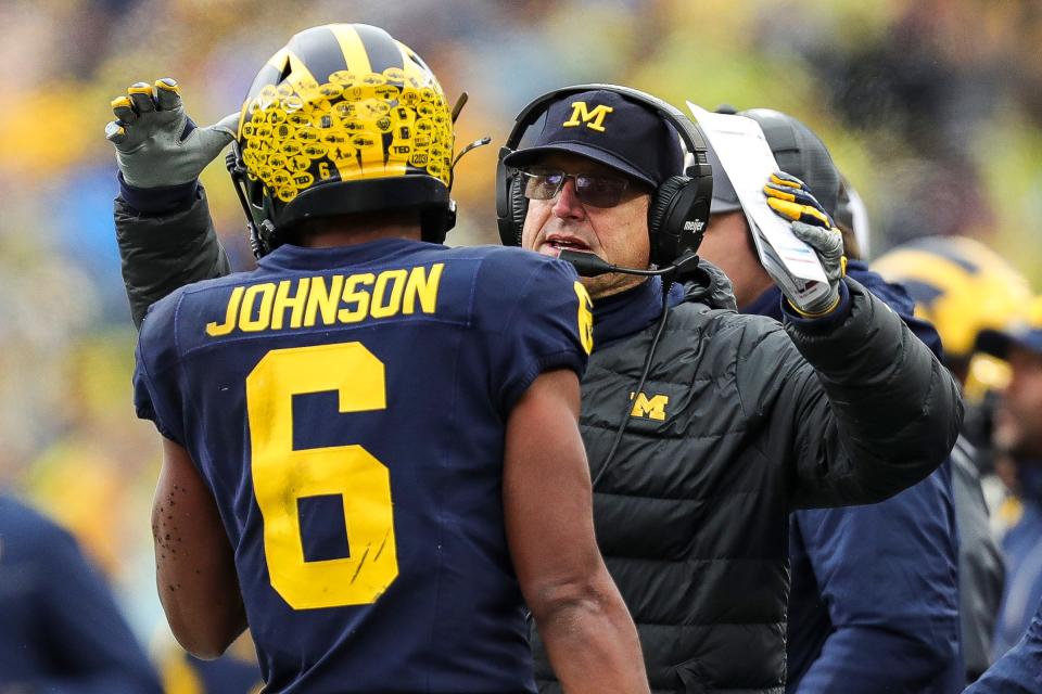 Michigan coach Jim Harbaugh celebrates a play against Indiana with wide receiver Cornelius Johnson during the first half of U-M's 52-7 win over Indiana on Saturday, Oct. 14, 2023, in Ann Arbor.