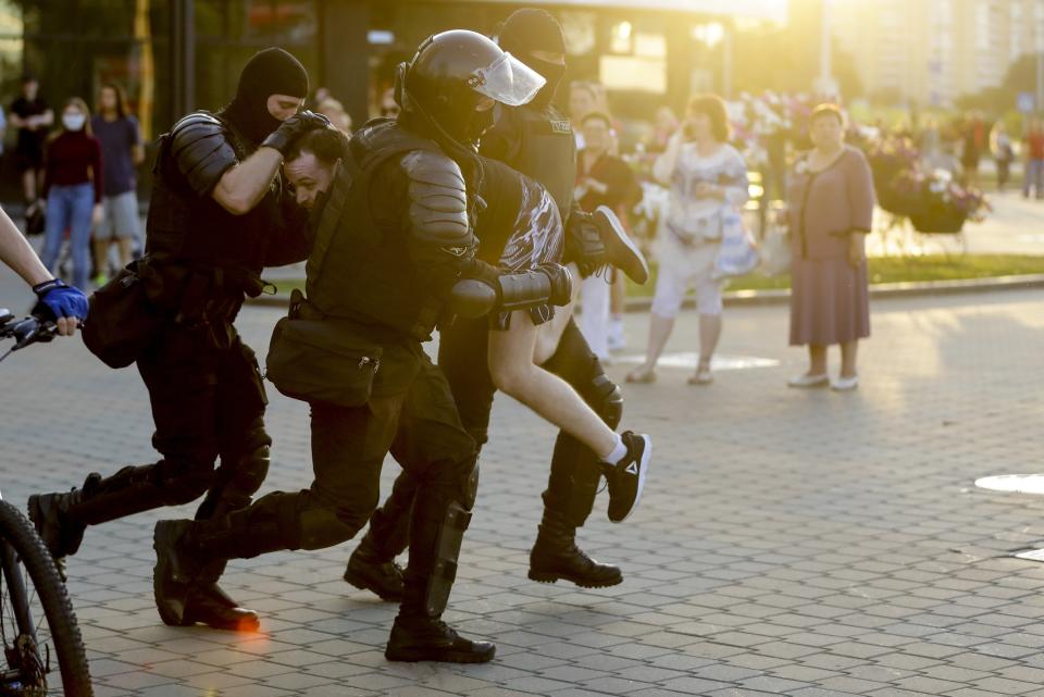 Police detain a man during a mass protest following presidential elections in Minsk, Belarus, Monday, Aug. 10, 2020. Thousands of people have protested in Belarus for a second straight night after official results from weekend elections gave an overwhelming victory to authoritarian President Alexander Lukashenko, extending his 26-year rule. A heavy police contingent blocked central squares and avenues, moving quickly to disperse protesters and detained dozens. (AP Photo/Sergei Grits)