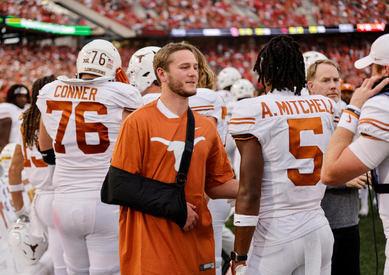 HOUSTON, TEXAS - OCTOBER 21: Quinn Ewers #3 of the Texas Longhorns wears a sling while congratulating Adonai Mitchell #5 after a touchdown in the second half against the Houston Cougars at TDECU Stadium on October 21, 2023 in Houston, Texas. (Photo by Tim Warner/Getty Images)