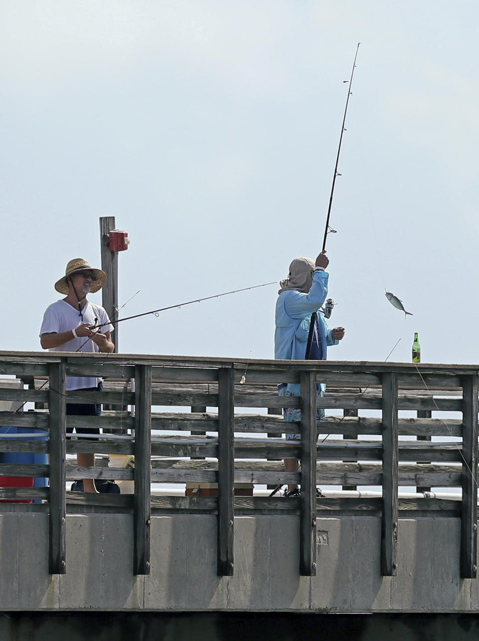 People fishing at Dania Beach Pier on Saturday, August 31, 2019 at Dania Beach in Florida. As of the 11 a.m. advisory, Hurricane Dorian is a category 4 storm. (David Santiago/Miami Herald via AP)