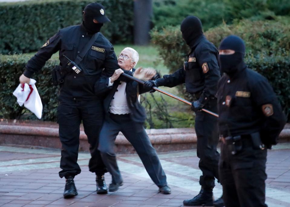 Opposition activist Nina Baginskaya, 73, center, struggles with police during a Belarusian opposition supporters rally at Independence Square in Minsk, Belarus, Wednesday, Aug. 26, 2020. Police in Belarus have dispersed protesters who gathered on the capital's central square, detaining dozens. The crackdown in Independence Square on Wednesday comes on the 18th straight day of protests pushing for the resignation of Belarus' authoritarian President Alexander Lukashenko. (AP Photo/Dmitri Lovetsky) ORG XMIT: PEA403